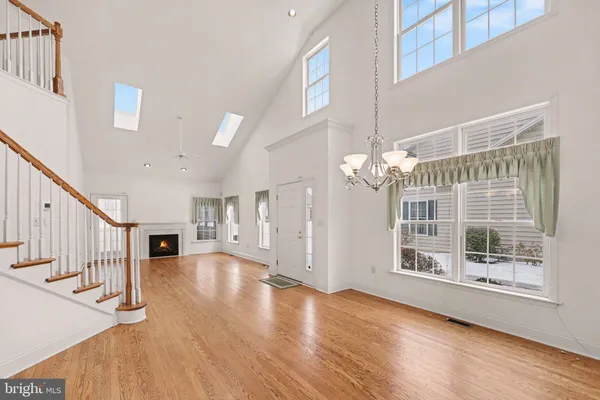 a view of a room with wooden floor and windows