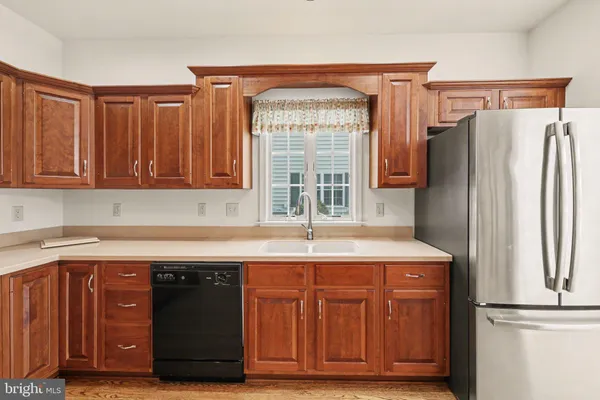 a kitchen with granite countertop a refrigerator and a sink