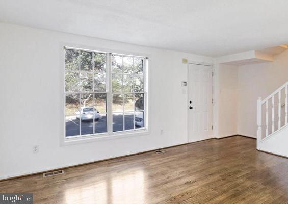 1711 Jacobs Meadow Drive Severn, MD 21144 - Photo 2 of 16 a view of empty room with wooden floor and fan