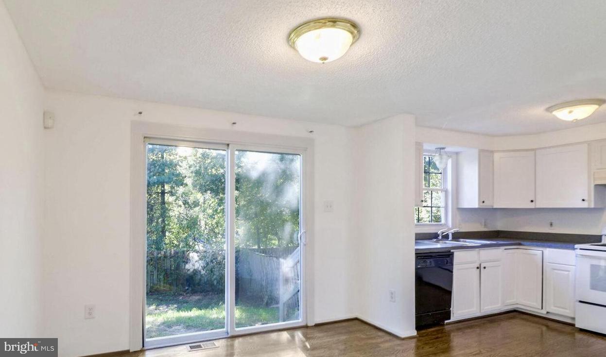 1711 Jacobs Meadow Drive Severn, MD 21144 - Photo 4 of 16 a kitchen with granite countertop a stove and white cabinets
