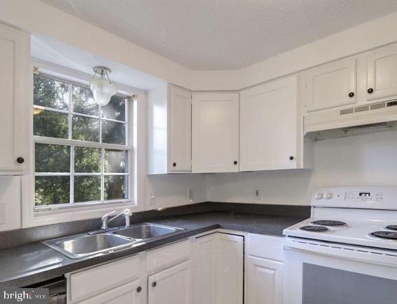 1711 Jacobs Meadow Drive Severn, MD 21144 - Photo 5 of 16 a kitchen with granite countertop cabinets sink and window
