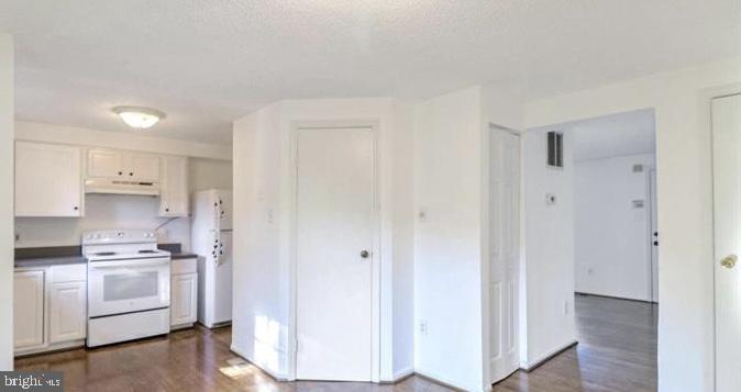 1711 Jacobs Meadow Drive Severn, MD 21144 - Photo 6 of 16 a kitchen with white cabinets and white appliances