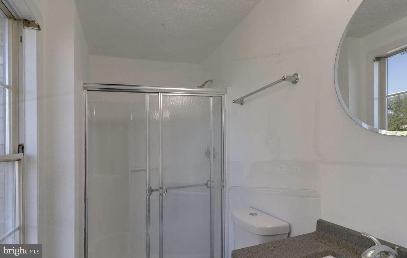 1711 Jacobs Meadow Drive Severn, MD 21144 - Photo 10 of 16 a bathroom with a shower and toilet