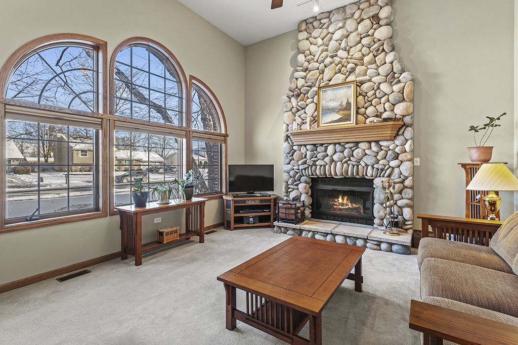 1011 Ranchwood Drive Shorewood, IL 60404 - Photo 2 of 18 a living room with furniture a flat screen tv and a fireplace
