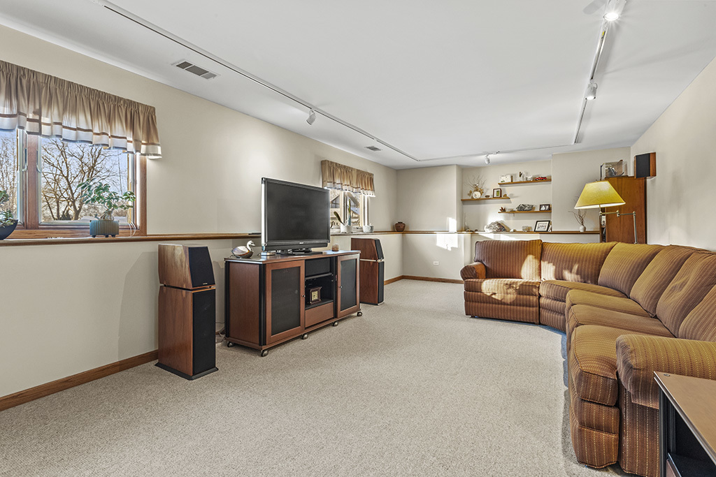 1011 Ranchwood Drive Shorewood, IL 60404 - Photo 6 of 18 a living room with furniture a flat screen tv and a window