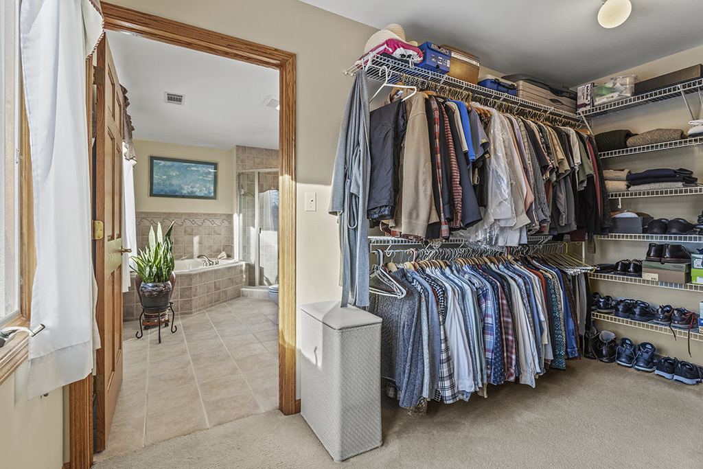 1011 Ranchwood Drive Shorewood, IL 60404 - Photo 10 of 18 a view of walk in closet with clothes and shoes