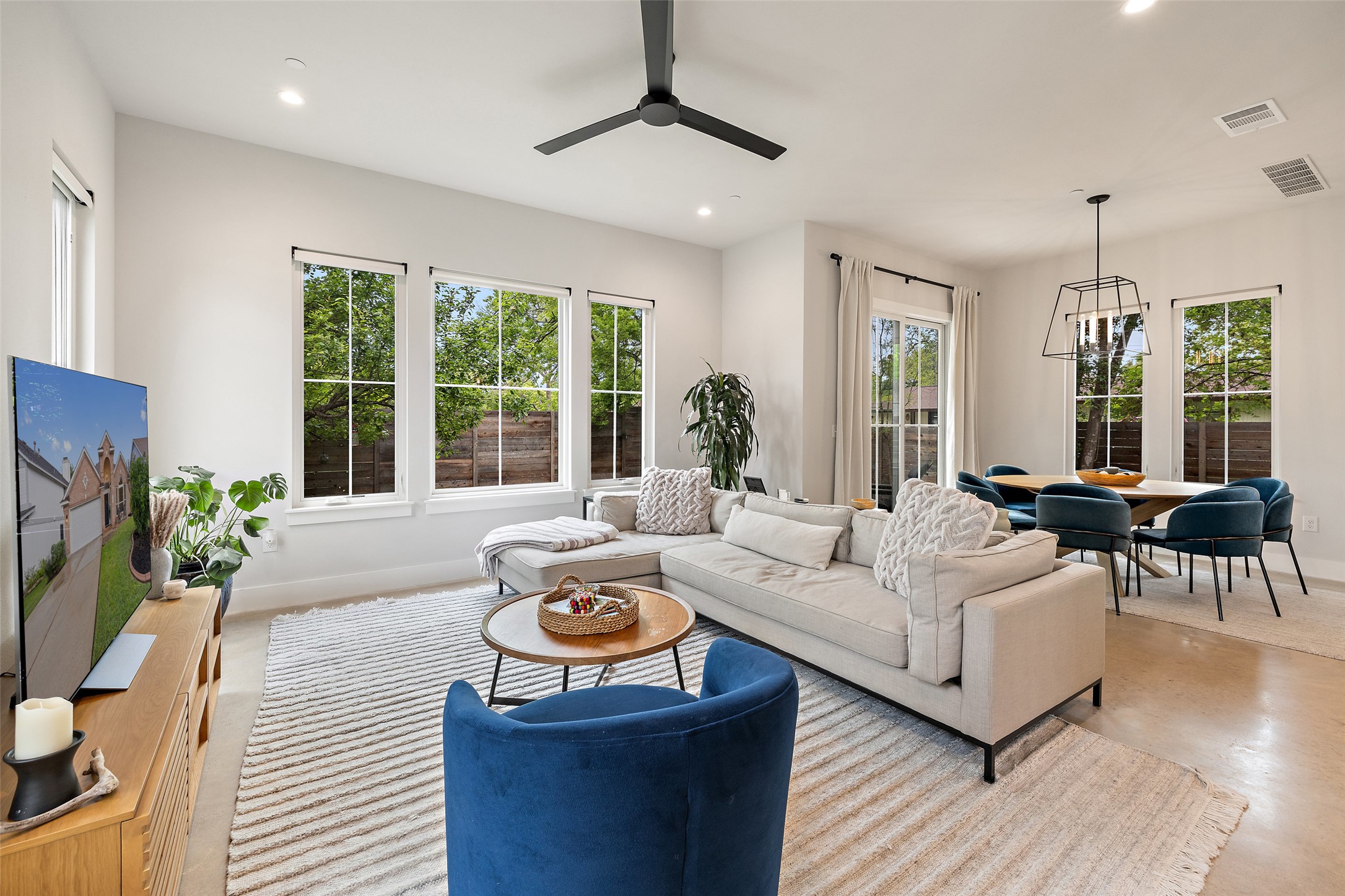 1504 Ruth Avenue, Unit 3 Austin, TX 78757 - Photo 39 of 39 An open floorplan seamlessly connects the living and dining areas, illuminated by abundant natural light.