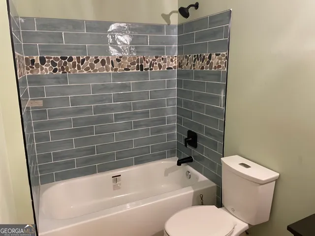 a bathroom with a toilet and shower