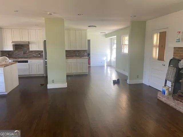 a view of kitchen with furniture and wooden floor