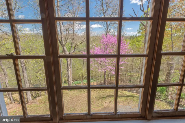 a view of a house with a window and wooden fence