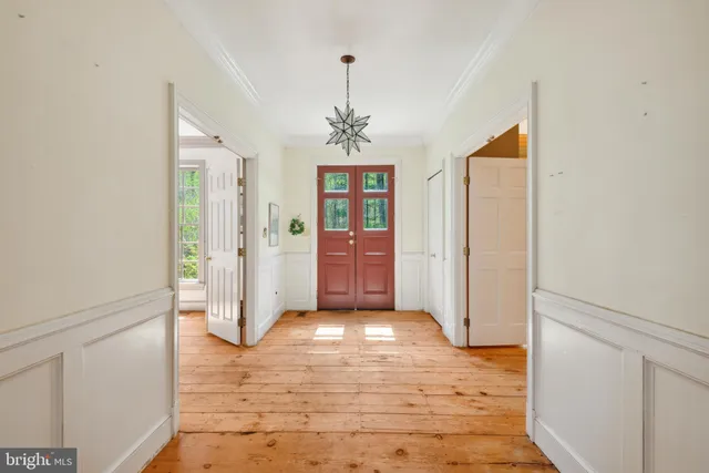 a view of empty room with wooden floor and fireplace