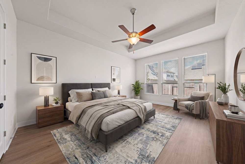 Warm wood flooring and an elegant recessed ceiling define this tranquil sleeping space.