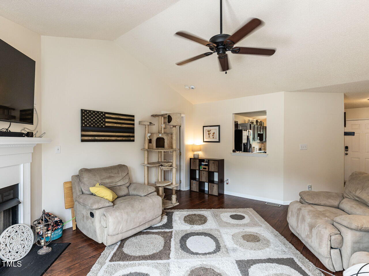 1955 Ranch Road Clayton, NC 27520 - Photo 11 of 28 a living room with furniture a fireplace and a flat screen tv