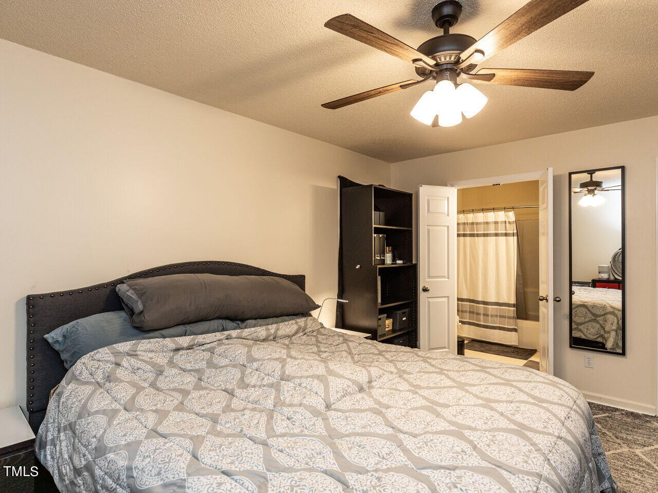 1955 Ranch Road Clayton, NC 27520 - Photo 13 of 28 a bedroom with a large bed and flat tv screen on dresser
