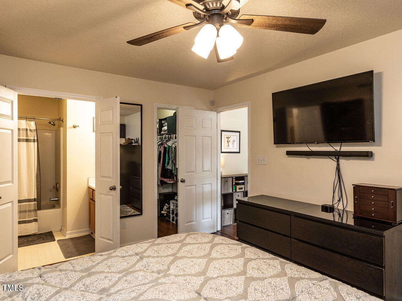 1955 Ranch Road Clayton, NC 27520 - Photo 14 of 28 a bedroom with a bed and a flat screen tv