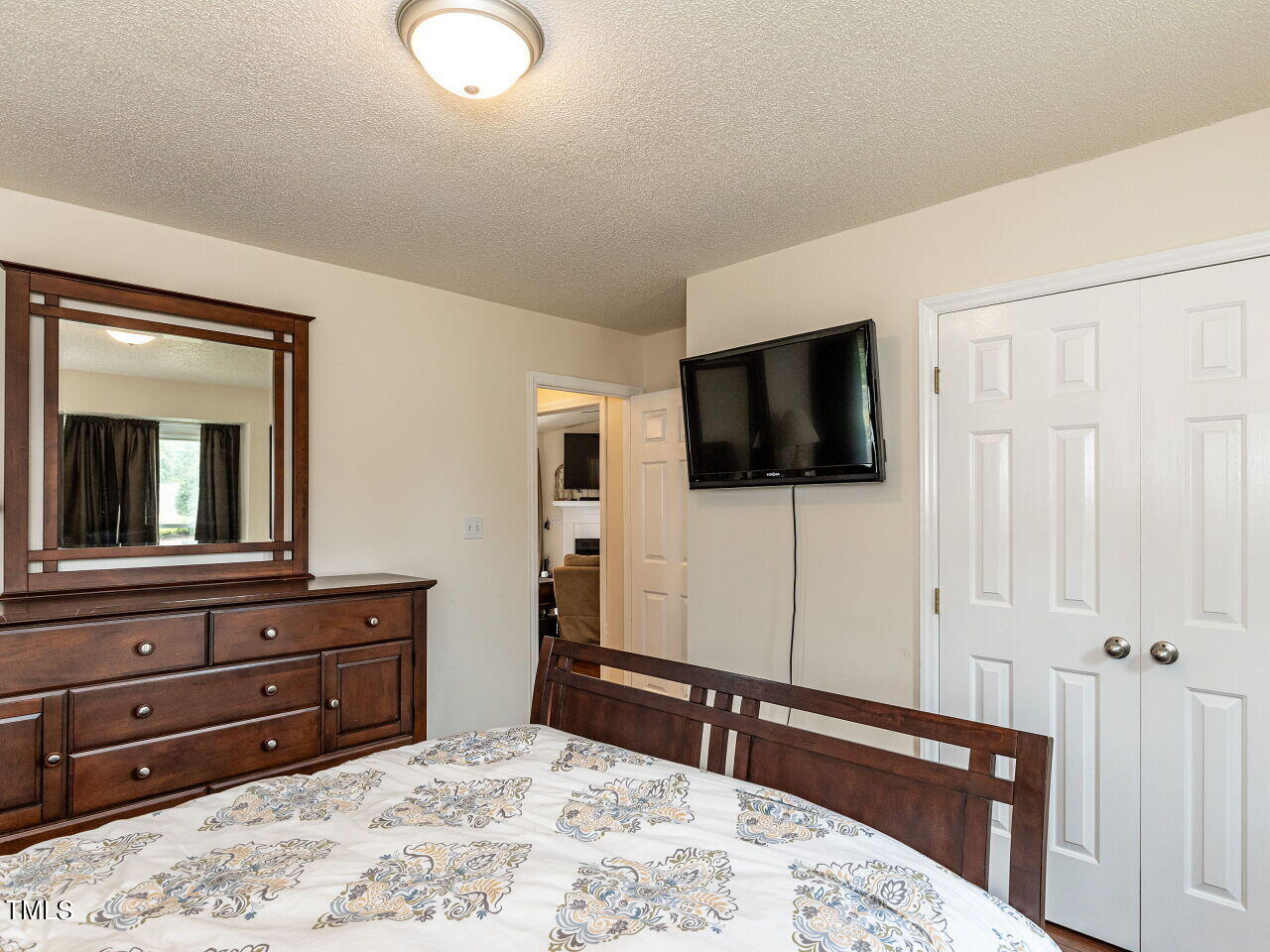 1955 Ranch Road Clayton, NC 27520 - Photo 18 of 28 a bedroom with a bed and a flat screen tv