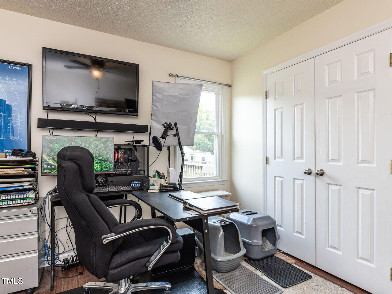 1955 Ranch Road Clayton, NC 27520 - Photo 22 of 28 a view of a workspace with furniture and a flat screen tv