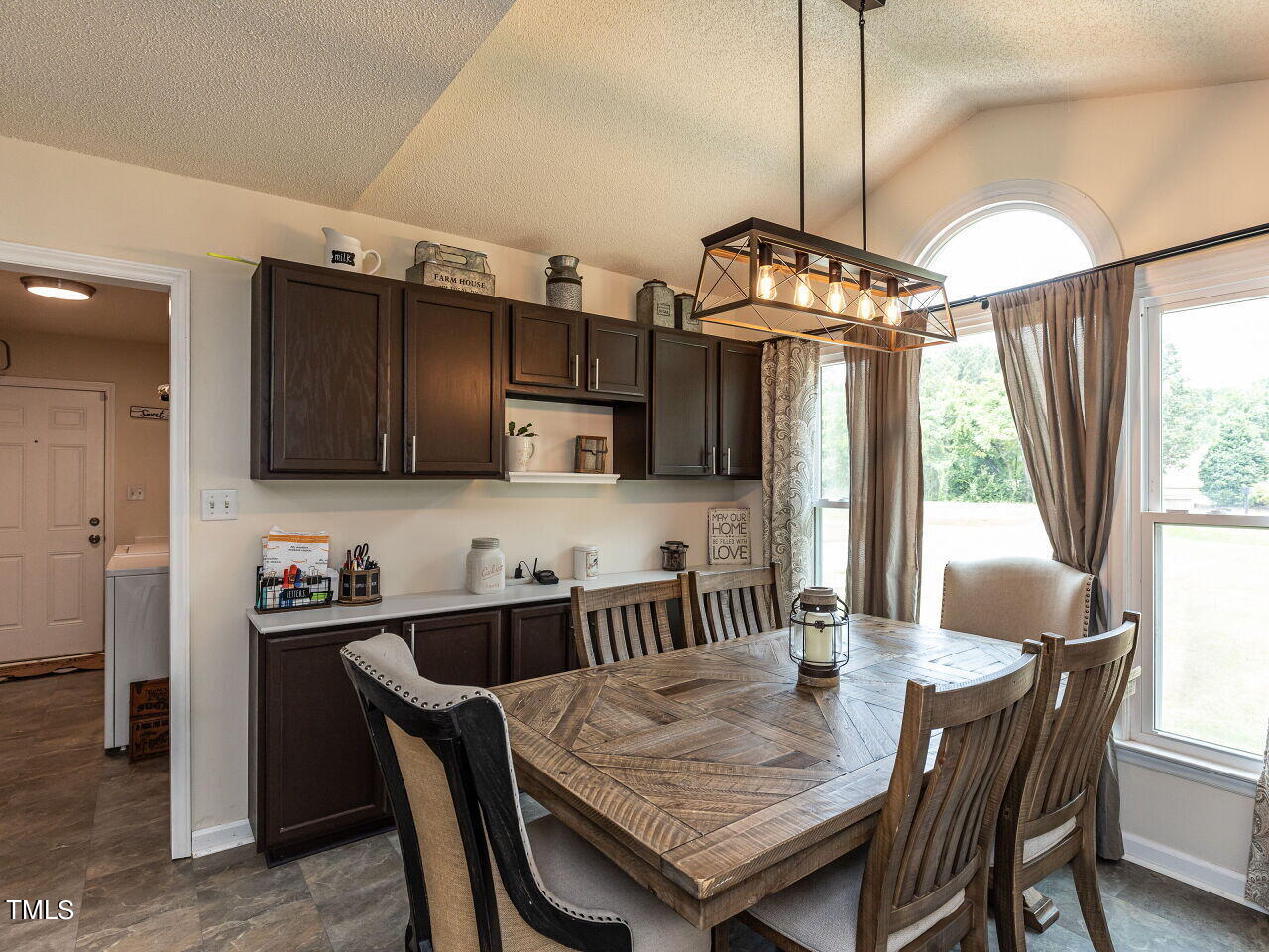 1955 Ranch Road Clayton, NC 27520 - Photo 4 of 28 a dining room with furniture a chandelier and window