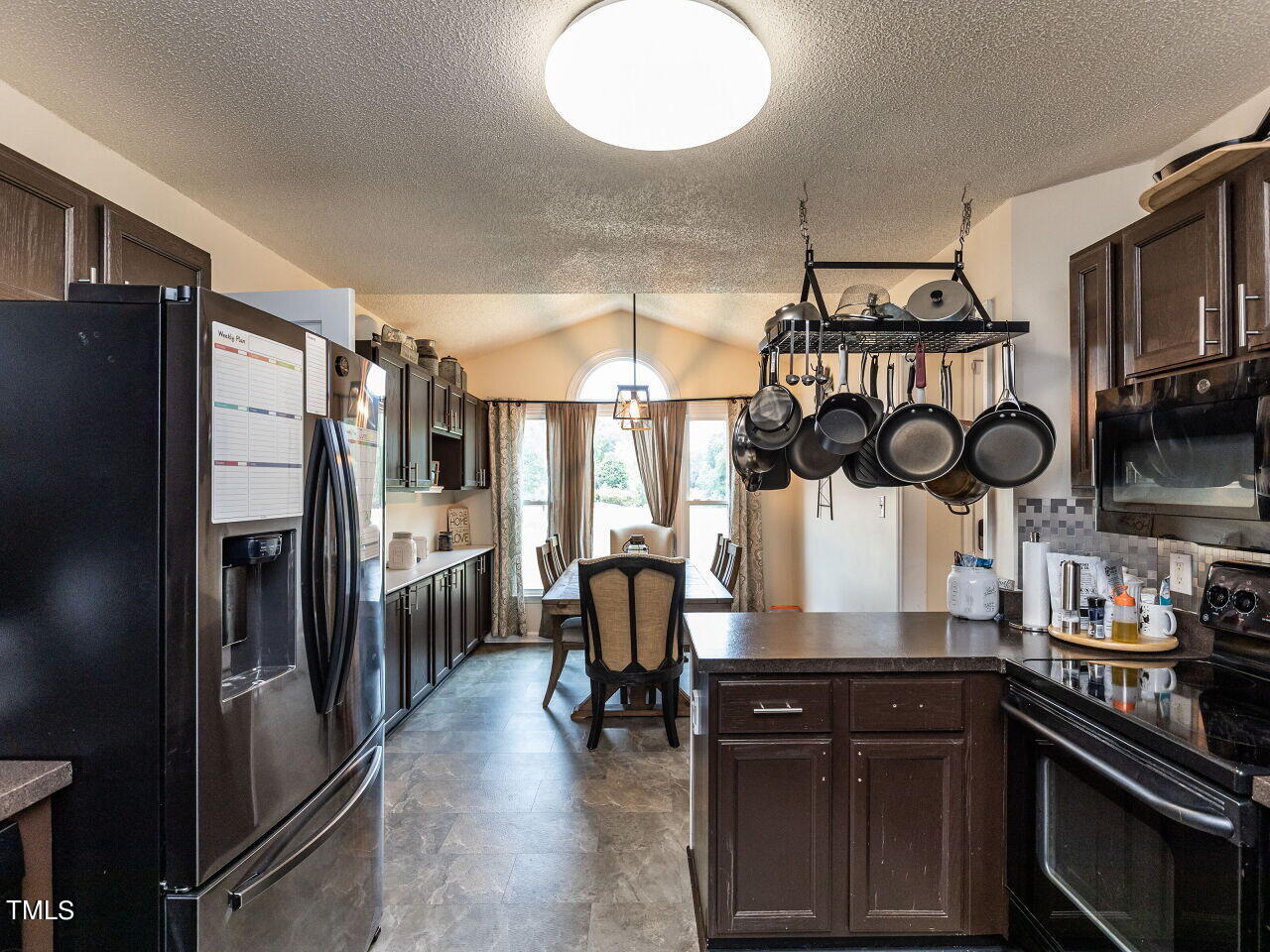 1955 Ranch Road Clayton, NC 27520 - Photo 8 of 28 a kitchen with stainless steel appliances granite countertop a stove and refrigerator