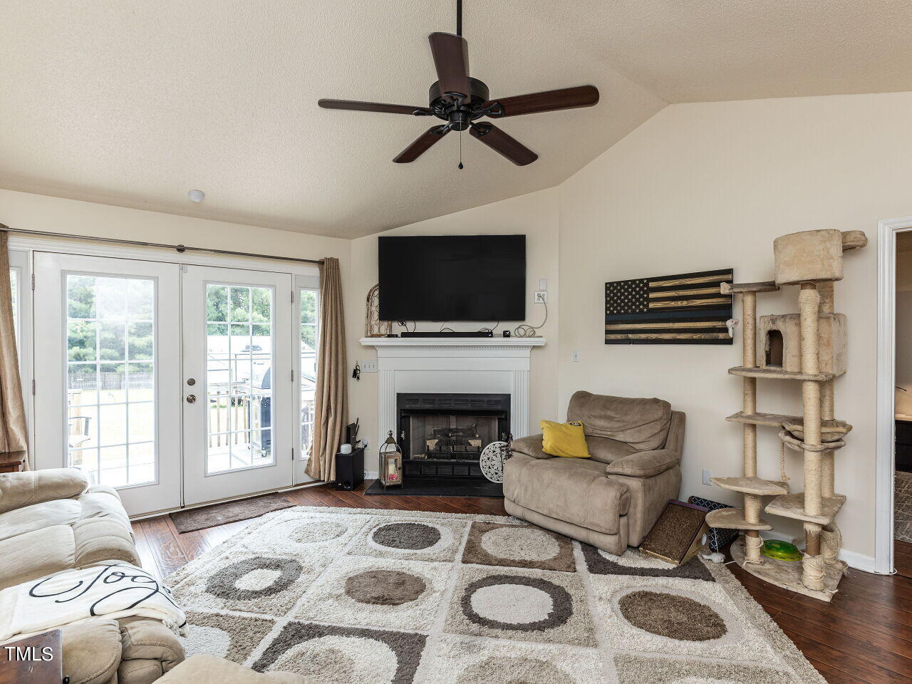 1955 Ranch Road Clayton, NC 27520 - Photo 9 of 28 a living room with furniture a flat screen tv and a fireplace