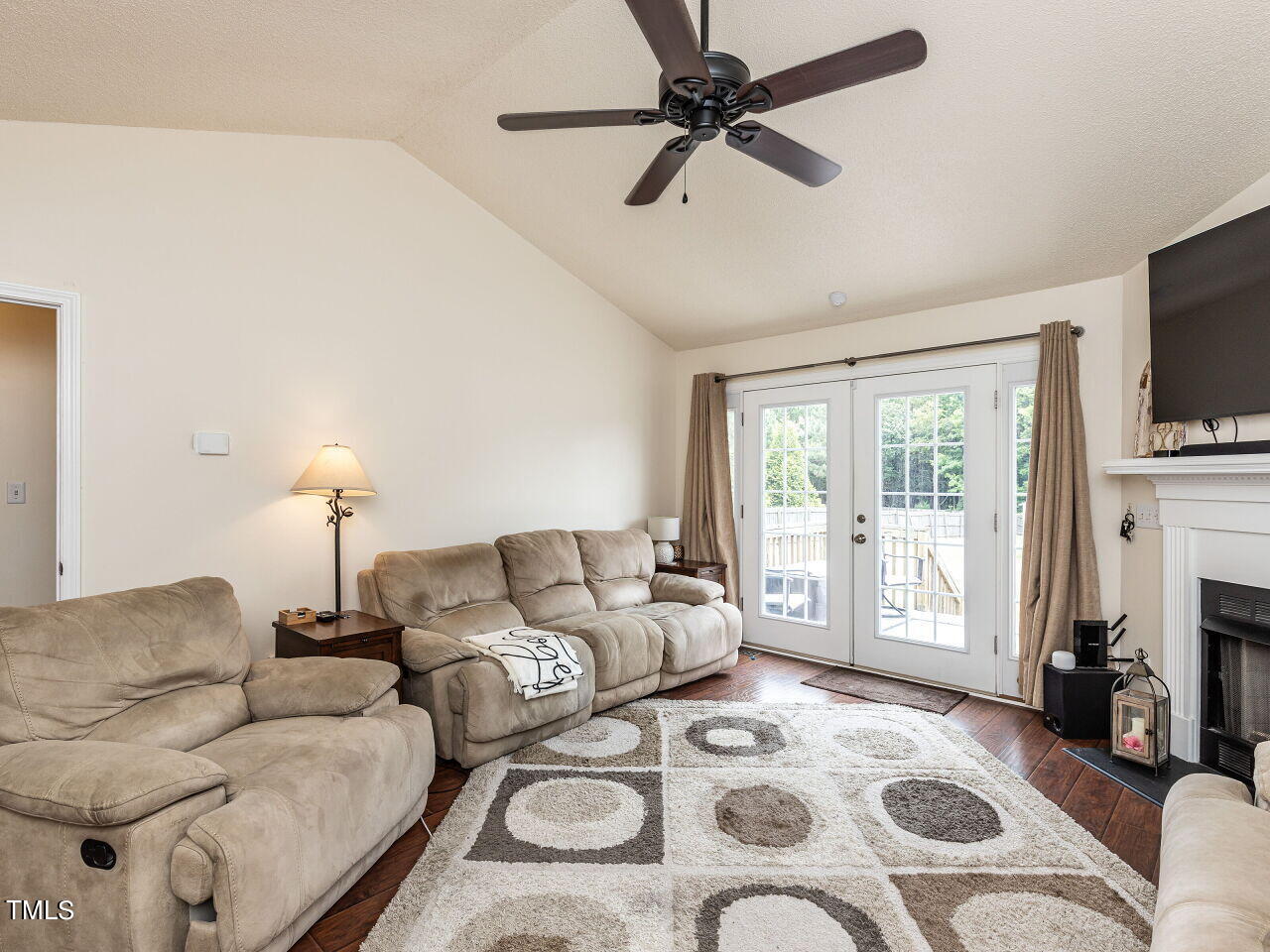 1955 Ranch Road Clayton, NC 27520 - Photo 10 of 28 a living room with furniture a flat screen tv and a fireplace