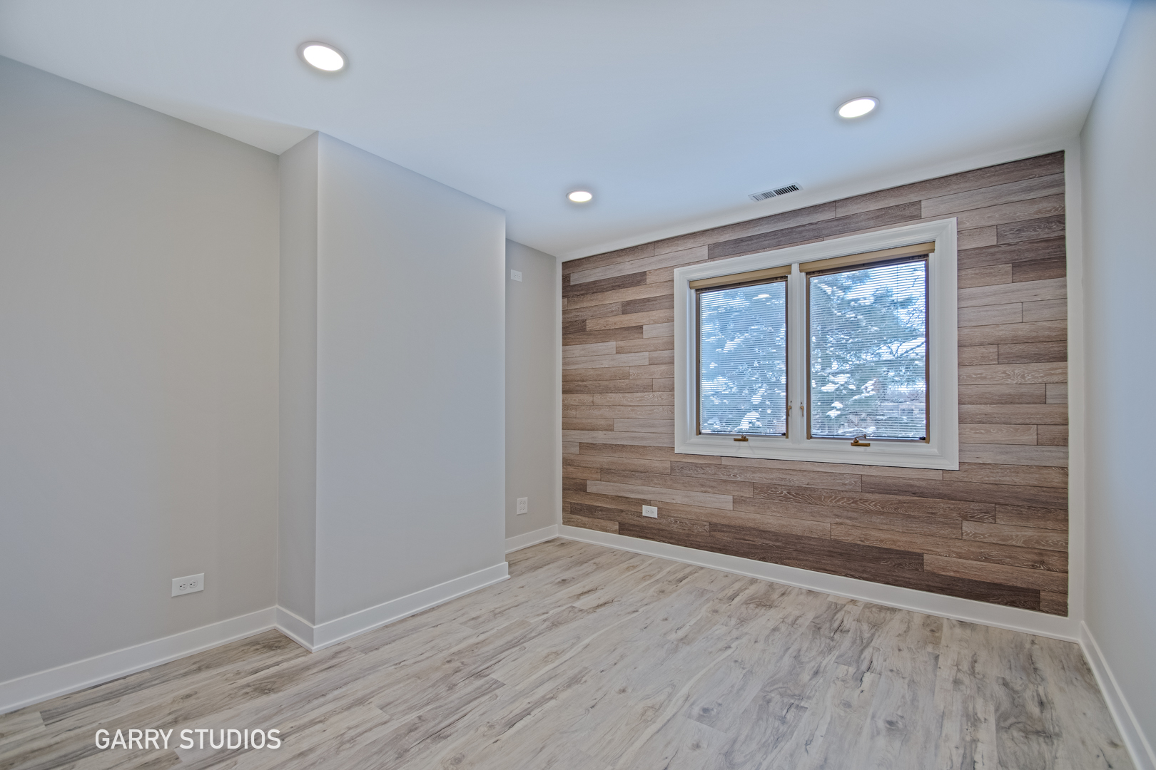 1460 Stonebridge Circle, Unit G9 Wheaton, IL 60189 - Photo 11 of 14 a view of an empty room with wooden floor and a window
