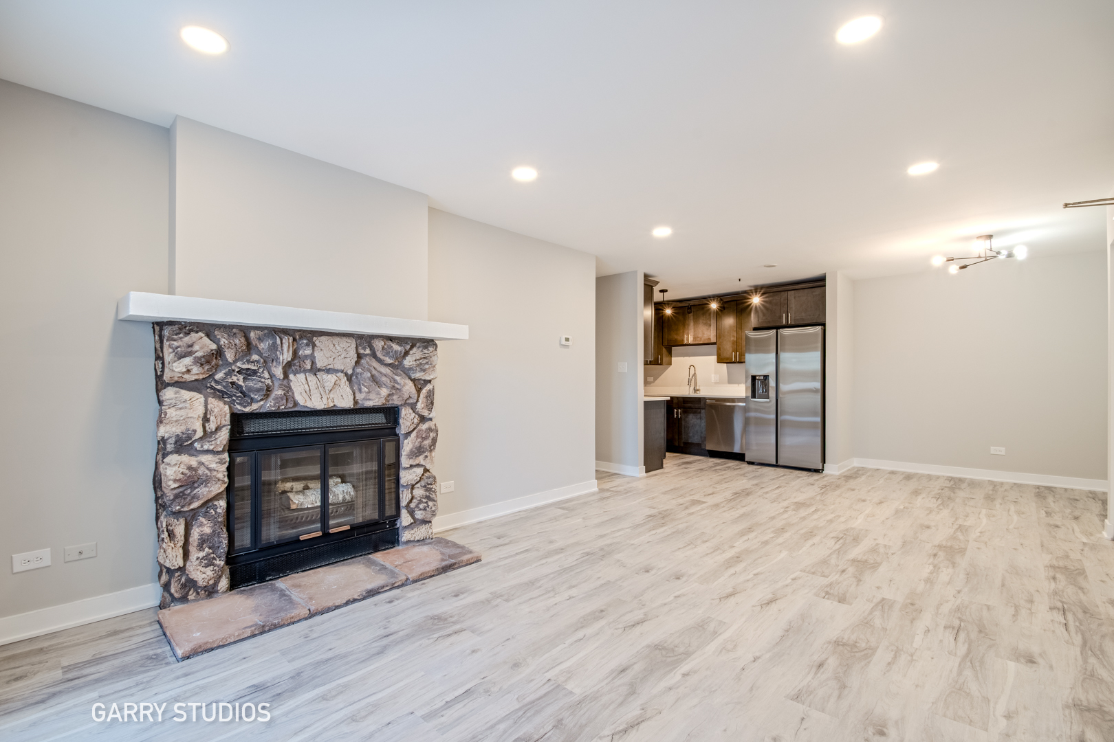 1460 Stonebridge Circle, Unit G9 Wheaton, IL 60189 - Photo 5 of 14 a view of an empty room with a fireplace