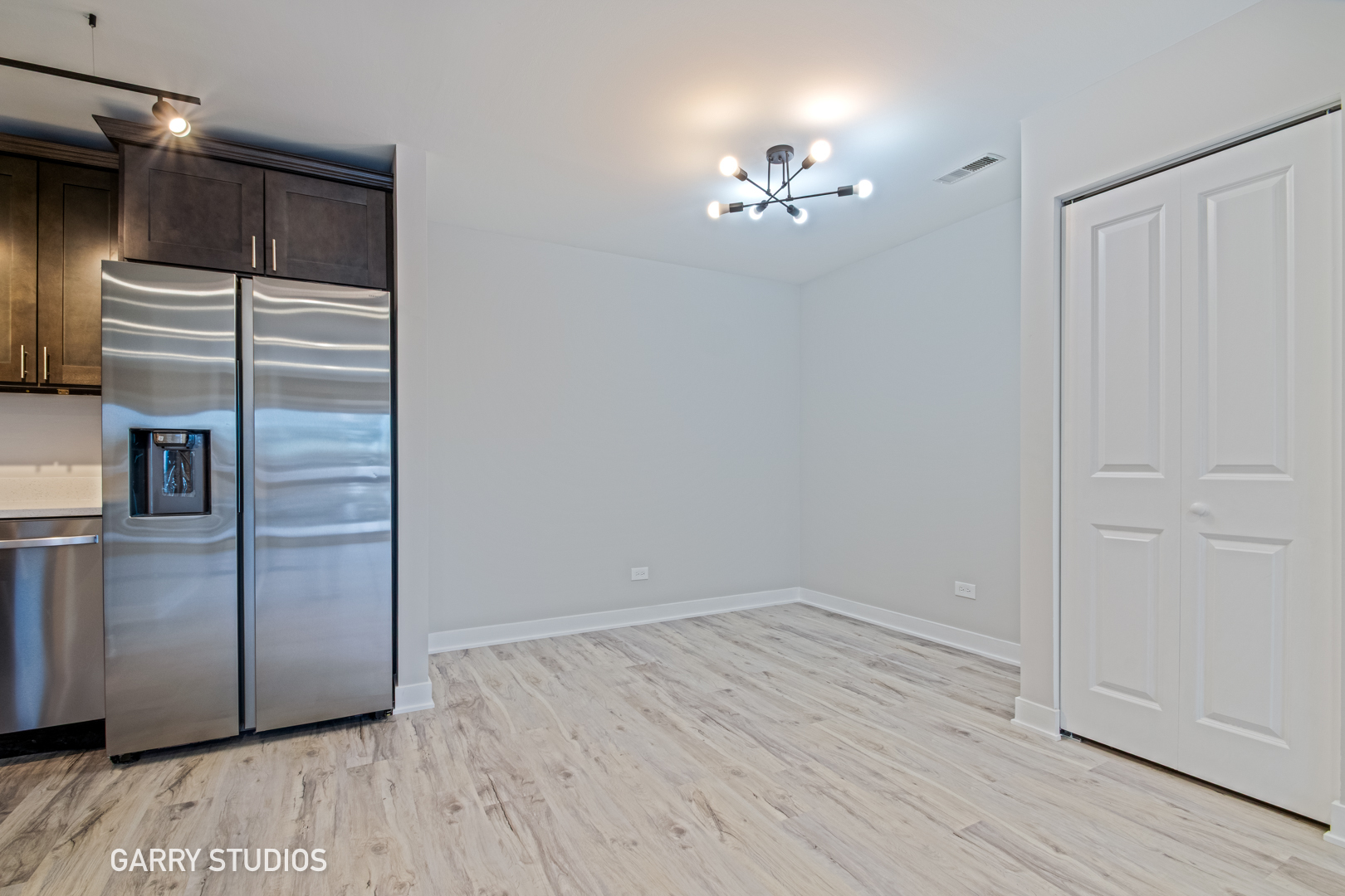 1460 Stonebridge Circle, Unit G9 Wheaton, IL 60189 - Photo 7 of 14 a view of an empty room with wooden floor