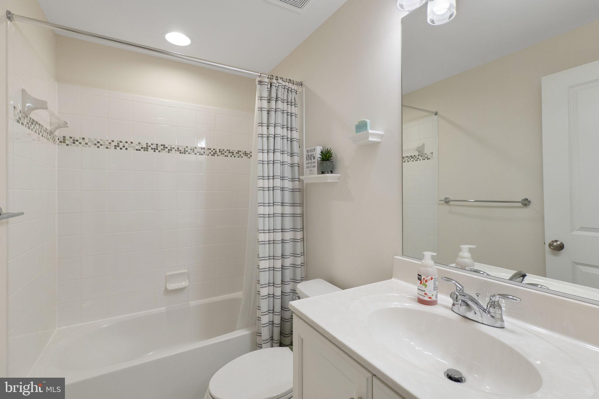 23902 Grapevine Ridge Terrace Clarksburg, MD 20871 - Photo 31 of 44 a bathroom with a sink toilet and shower