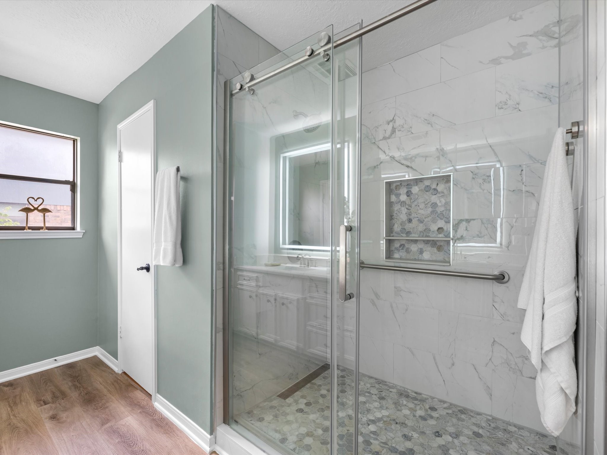 4002 Cujanes Street Pasadena, TX 77504 - Photo 17 of 26 a bathroom with a glass shower door