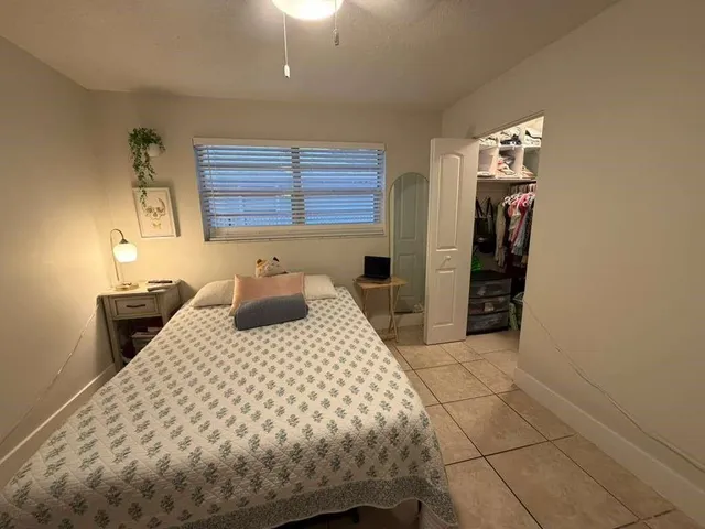 a bedroom with a bed and window
