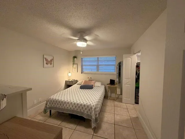a bedroom with a bed and a view of bathroom