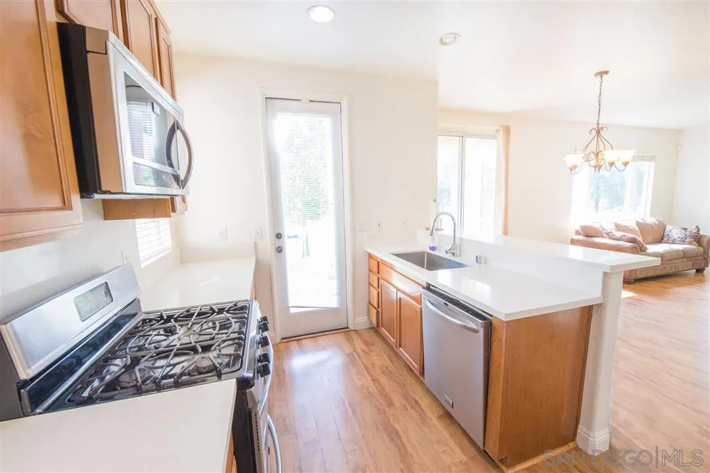 3267 Dehesa Road, Unit 65 El Cajon, CA 92019 - Photo 12 of 25 a kitchen with sink stove and refrigerator