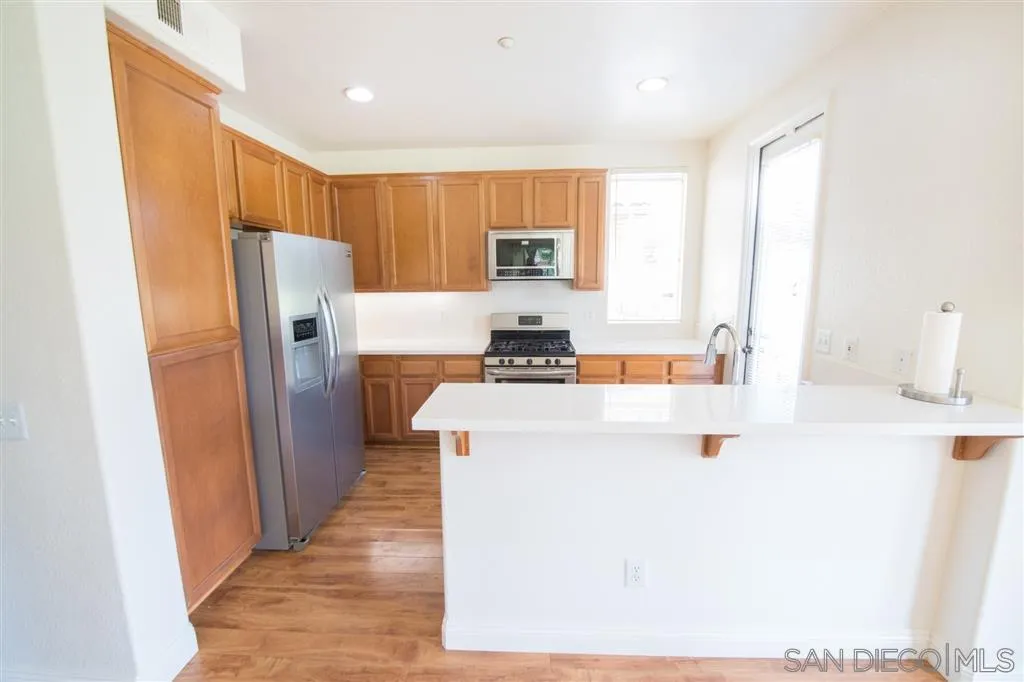 3267 Dehesa Road, Unit 65 El Cajon, CA 92019 - Photo 14 of 25 a kitchen with stainless steel appliances a refrigerator and a stove