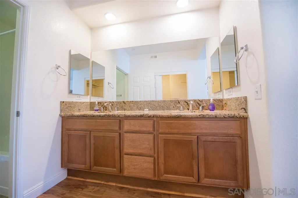 3267 Dehesa Road, Unit 65 El Cajon, CA 92019 - Photo 18 of 25 a bathroom with a double vanity sink and a mirror