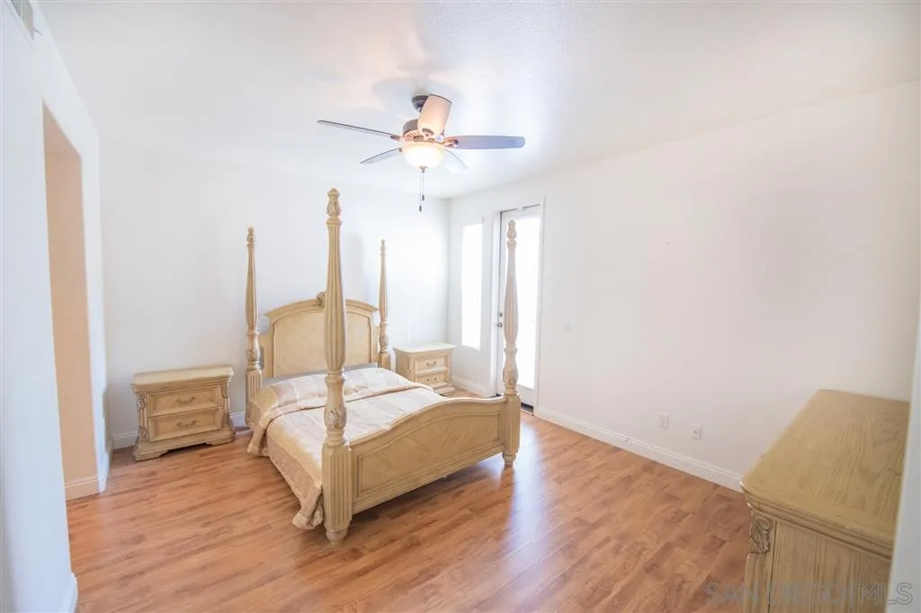 3267 Dehesa Road, Unit 65 El Cajon, CA 92019 - Photo 21 of 25 a bedroom with a bed and a chandelier