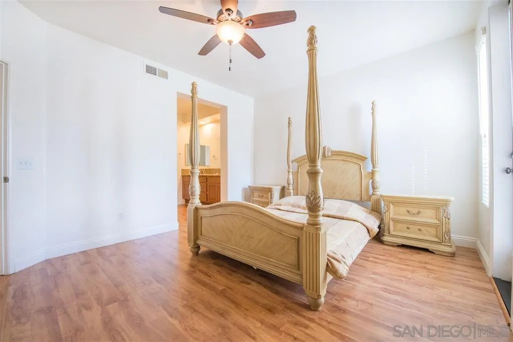 3267 Dehesa Road, Unit 65 El Cajon, CA 92019 - Photo 22 of 25 a bed room with a bed and a chandelier