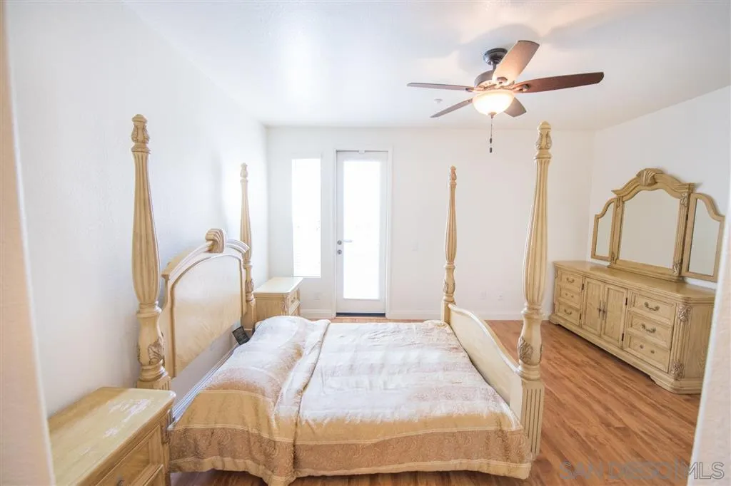 3267 Dehesa Road, Unit 65 El Cajon, CA 92019 - Photo 23 of 25 a bedroom with a large bed and a chandelier