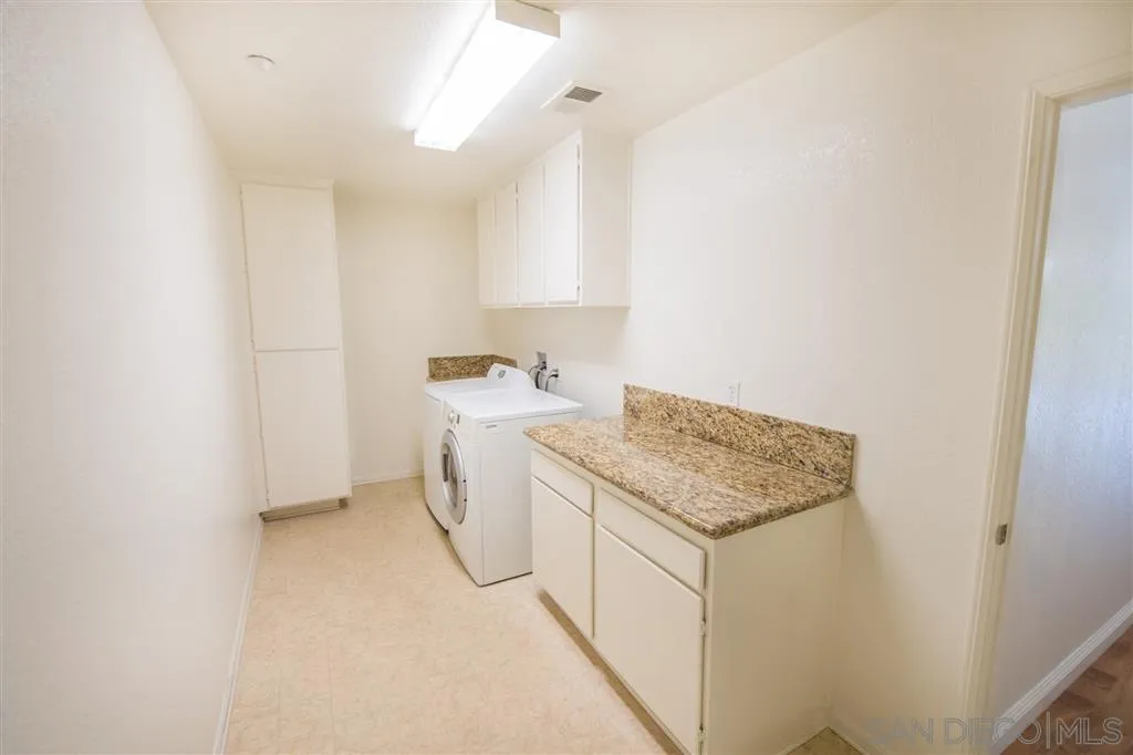 3267 Dehesa Road, Unit 65 El Cajon, CA 92019 - Photo 24 of 25 a utility room with cabinets washer and dryer