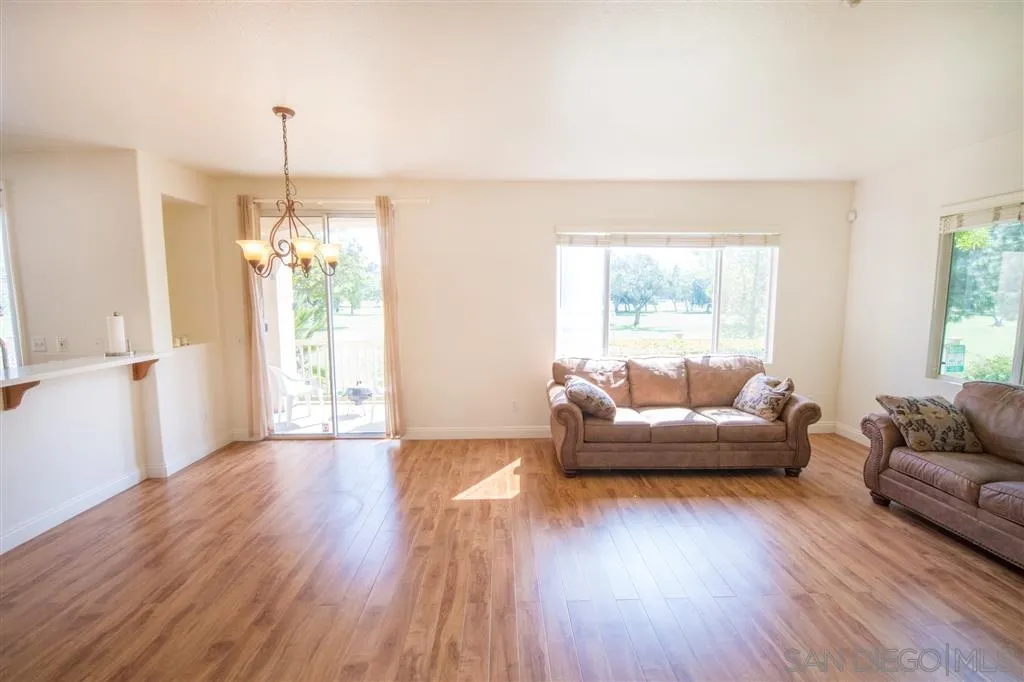 3267 Dehesa Road, Unit 65 El Cajon, CA 92019 - Photo 8 of 25 a living room with furniture and a chandelier