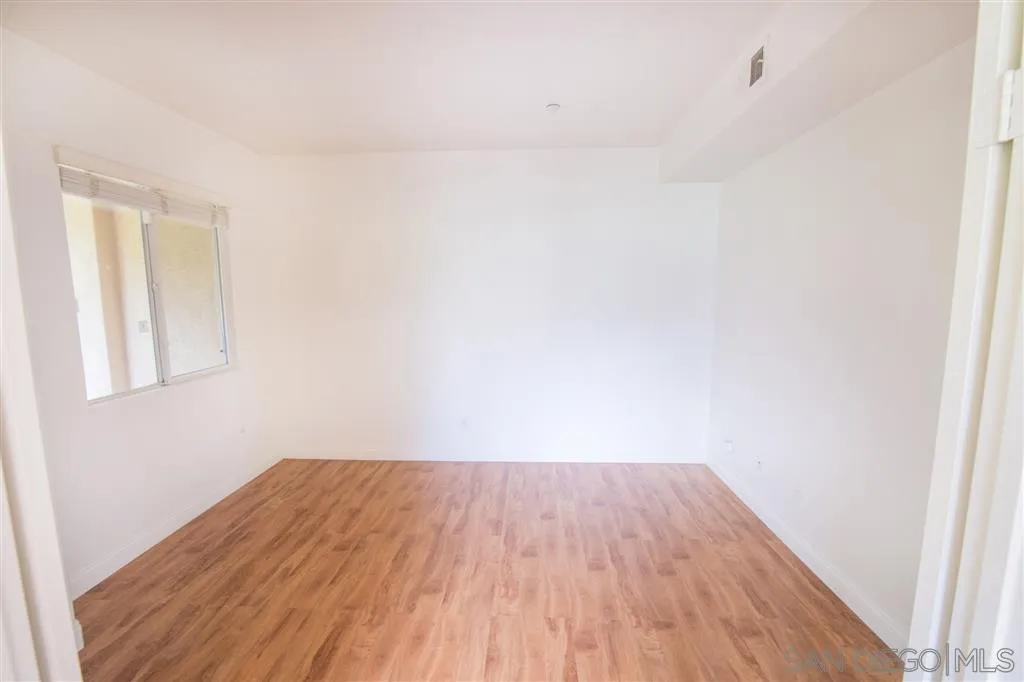 3267 Dehesa Road, Unit 65 El Cajon, CA 92019 - Photo 9 of 25 a view of a room with wooden floor and white walls