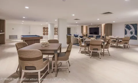 a dining room with furniture a window and kitchen
