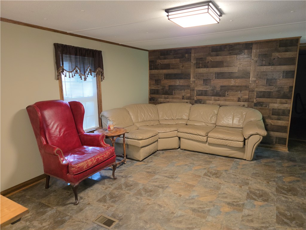238 Forest Lane Starr, SC 29684 - Photo 6 of 11 A relaxed living area offers a paneled accent wall and durable tile flooring.