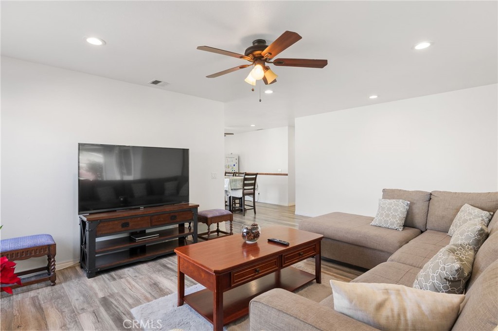 8548 Turlock Drive Riverside, CA 92504 - Photo 12 of 56 a living room with furniture and a flat screen tv