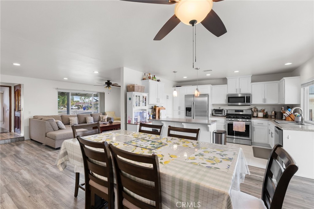 8548 Turlock Drive Riverside, CA 92504 - Photo 14 of 56 a living room with stainless steel appliances granite countertop furniture a fireplace a rug and white cabinets