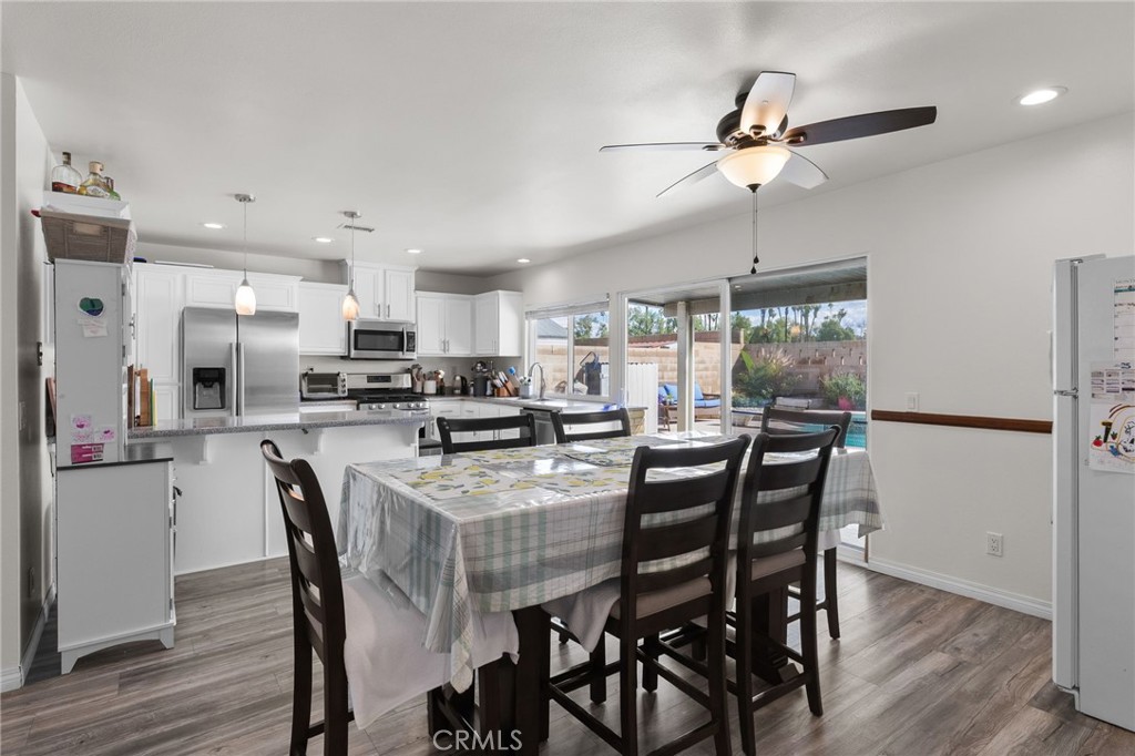 8548 Turlock Drive Riverside, CA 92504 - Photo 17 of 56 a kitchen with stainless steel appliances a table and chairs in it