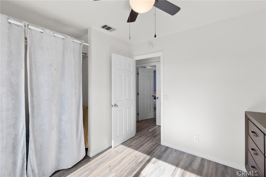8548 Turlock Drive Riverside, CA 92504 - Photo 27 of 56 a view of a hallway with wooden floor and closet