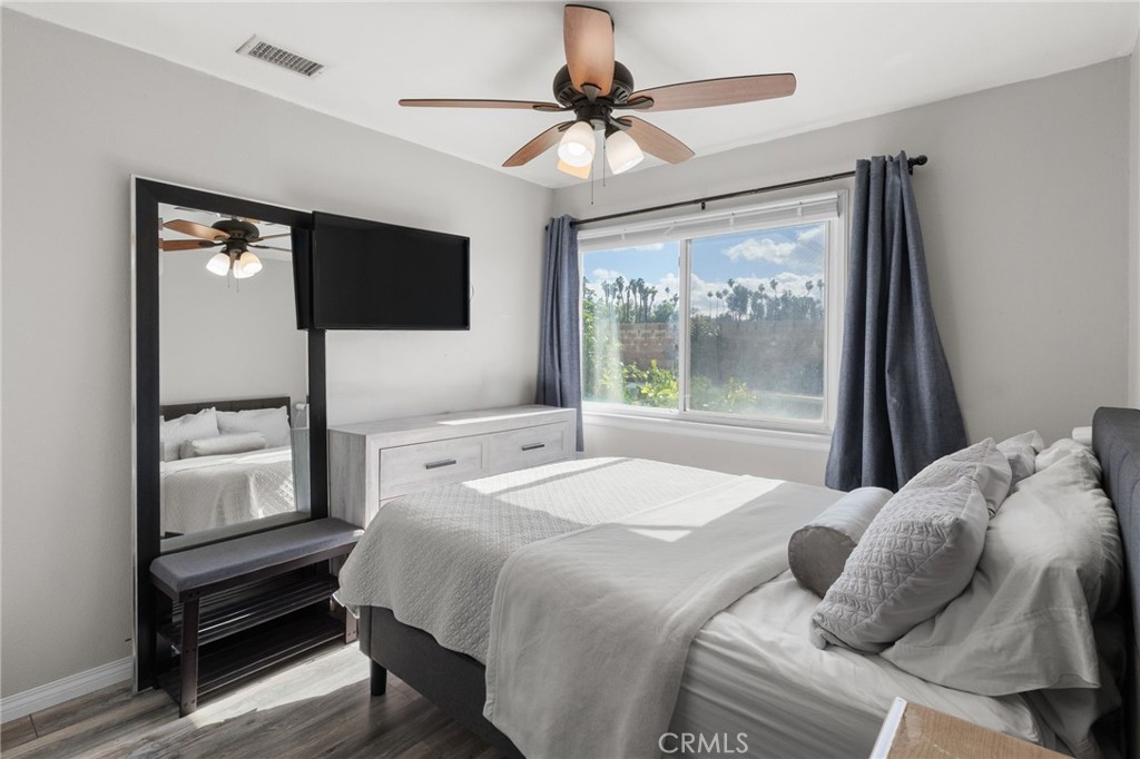 8548 Turlock Drive Riverside, CA 92504 - Photo 28 of 56 a bedroom with a bed and a flat screen tv