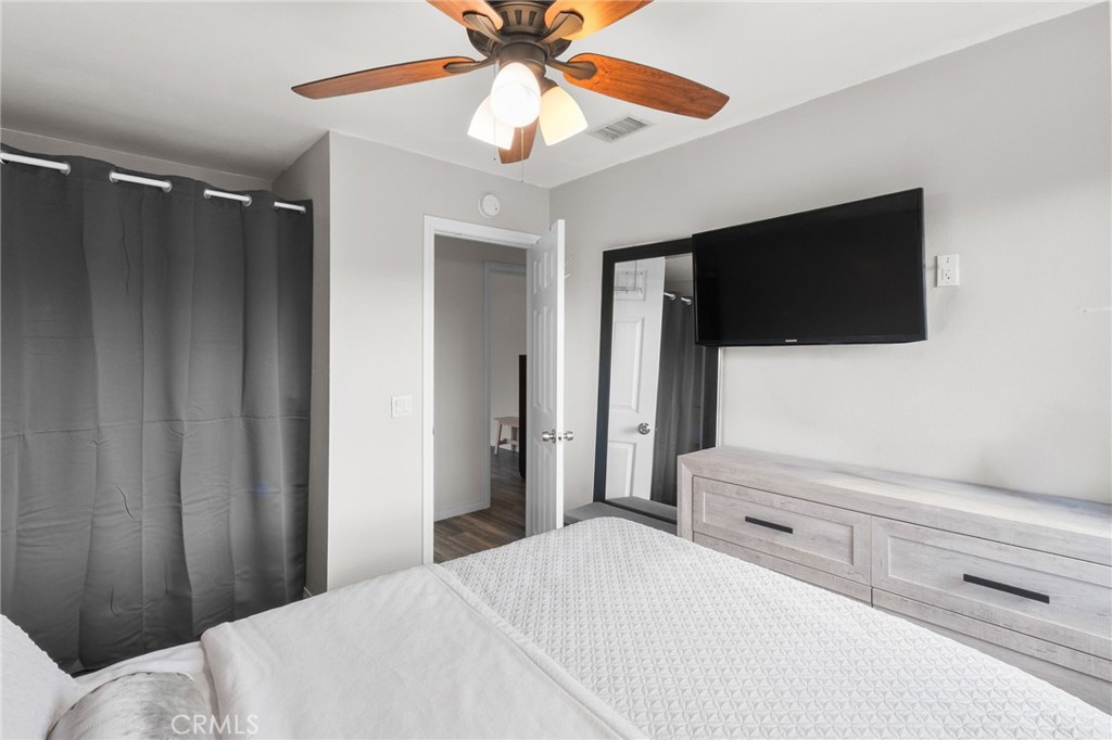 8548 Turlock Drive Riverside, CA 92504 - Photo 29 of 56 a bedroom with a bed and a flat screen tv