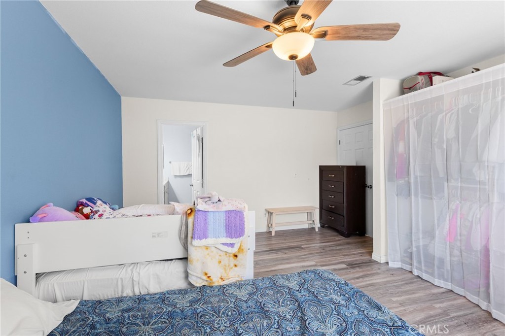 8548 Turlock Drive Riverside, CA 92504 - Photo 31 of 56 a bedroom with a bed and a chandelier